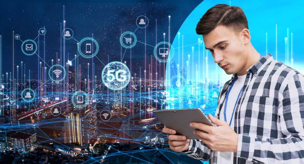 man-working-in-tablet-with-glowing-city-and-technologies-in-background