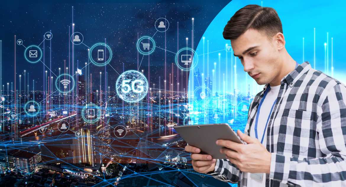 man-working-in-tablet-with-glowing-city-and-technologies-in-background