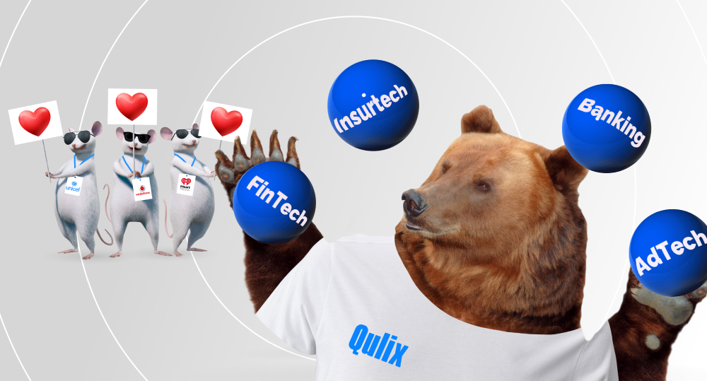 Bear wearing t-shirt with Qulix logo juggling balls, and three mice standing behind it with signs with hearts