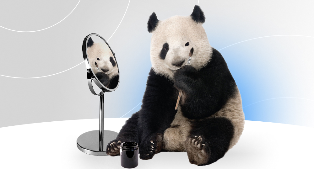 Panda sits in front of a mirror and disguises itself.